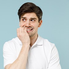 A nervous man biting his fingernails